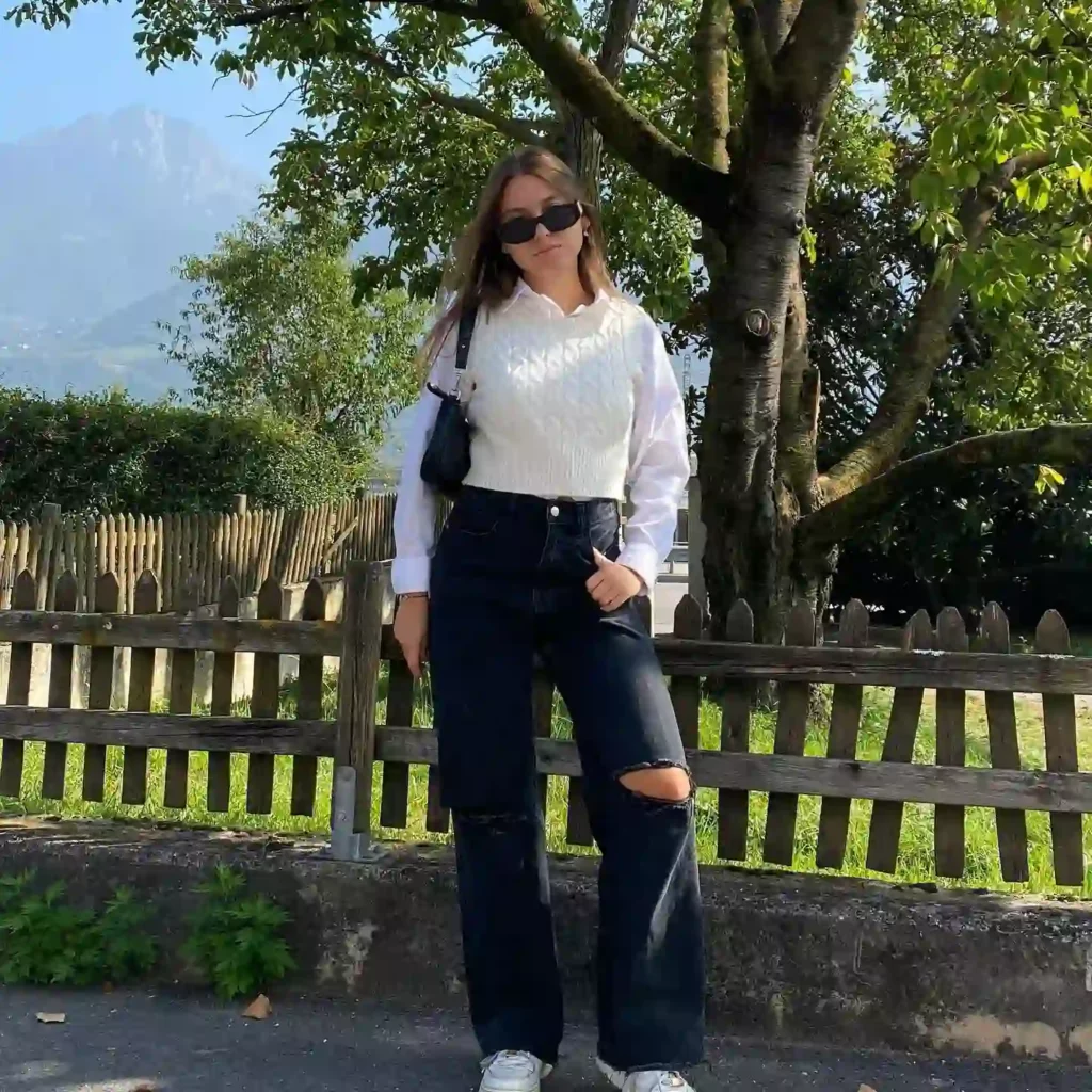 White Shirt Layered with Knit Vest and Black Jeans Office Outfit