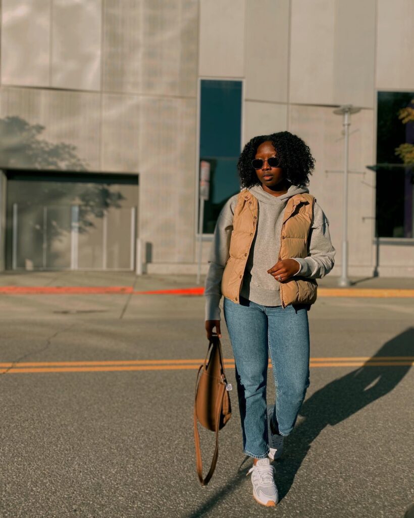Gray Hoodie and Tan Puffer Vest with Jeans Fall Outfit